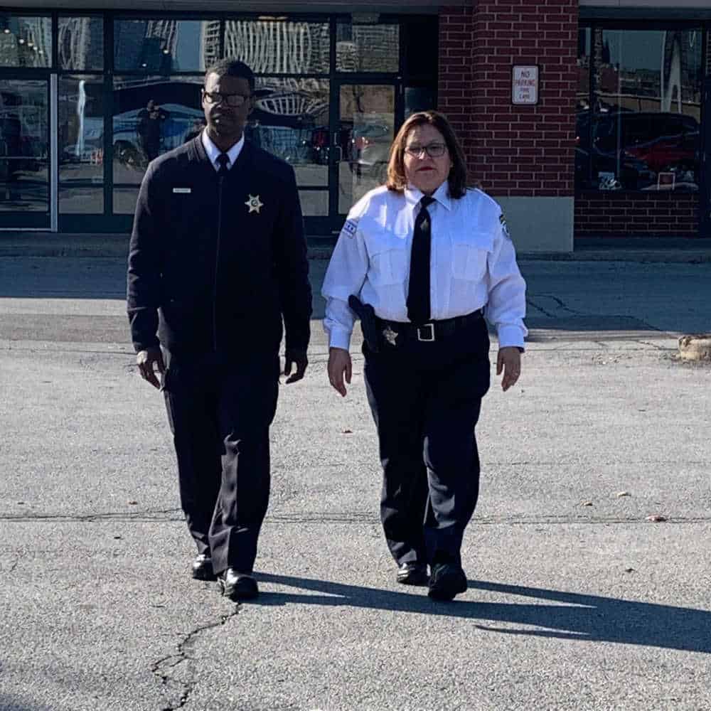 Villarreal Security Officers on Patrol – Professional Business Protection & Safety Two Villarreal Security Investigations officers walking through a commercial area, providing professional security services to ensure business safety and crime prevention.